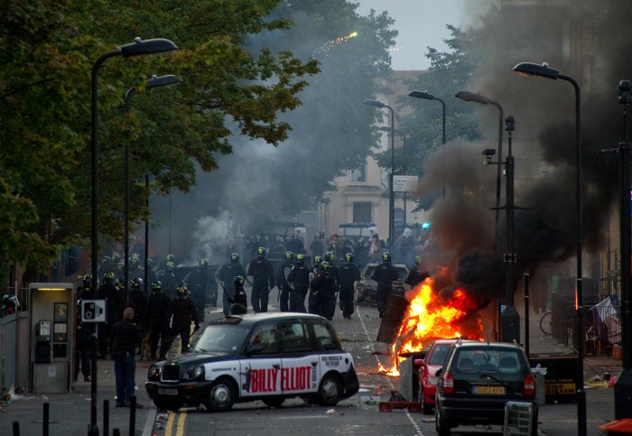 Policiais de choque avançam para conter manifestantes, nesta segunda-feira (8), em Londres - no terceiro dia de protestos na cidade